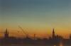 Opkomende zon boven Delft